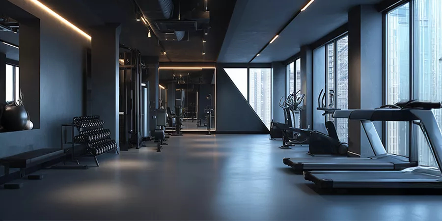 Frontalperspektive auf ein modernes Fitnessstudio mit Fitnessgeräten, Fenster und Gewichten